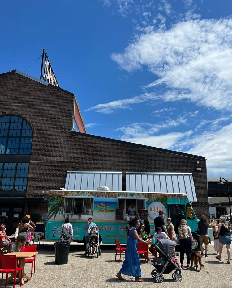 Aruba Freeze Food truck outside a building with a blue sky and clouds